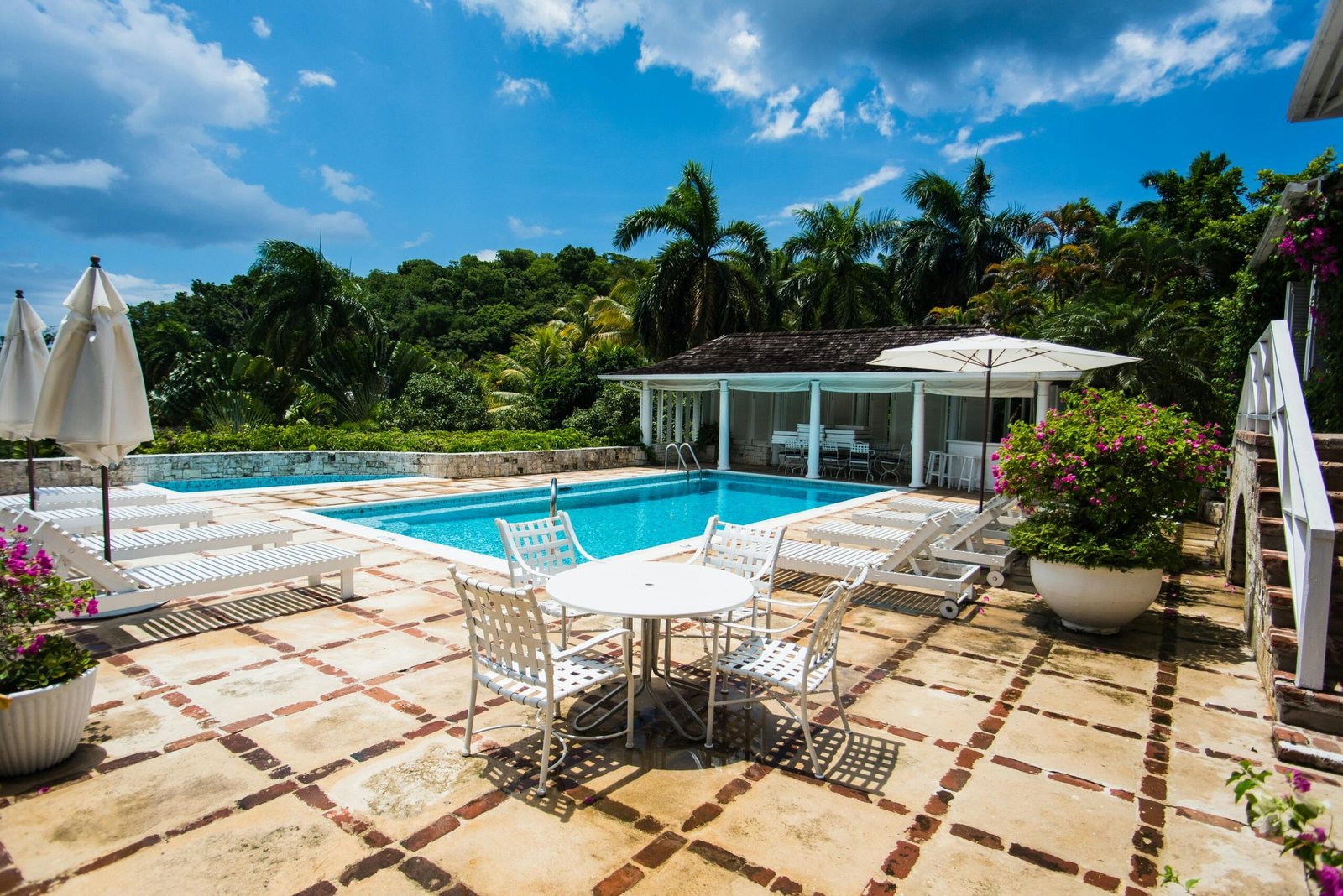 Discover a serene poolside escape surrounded by lush tropical greenery in Montego Bay, Jamaica.